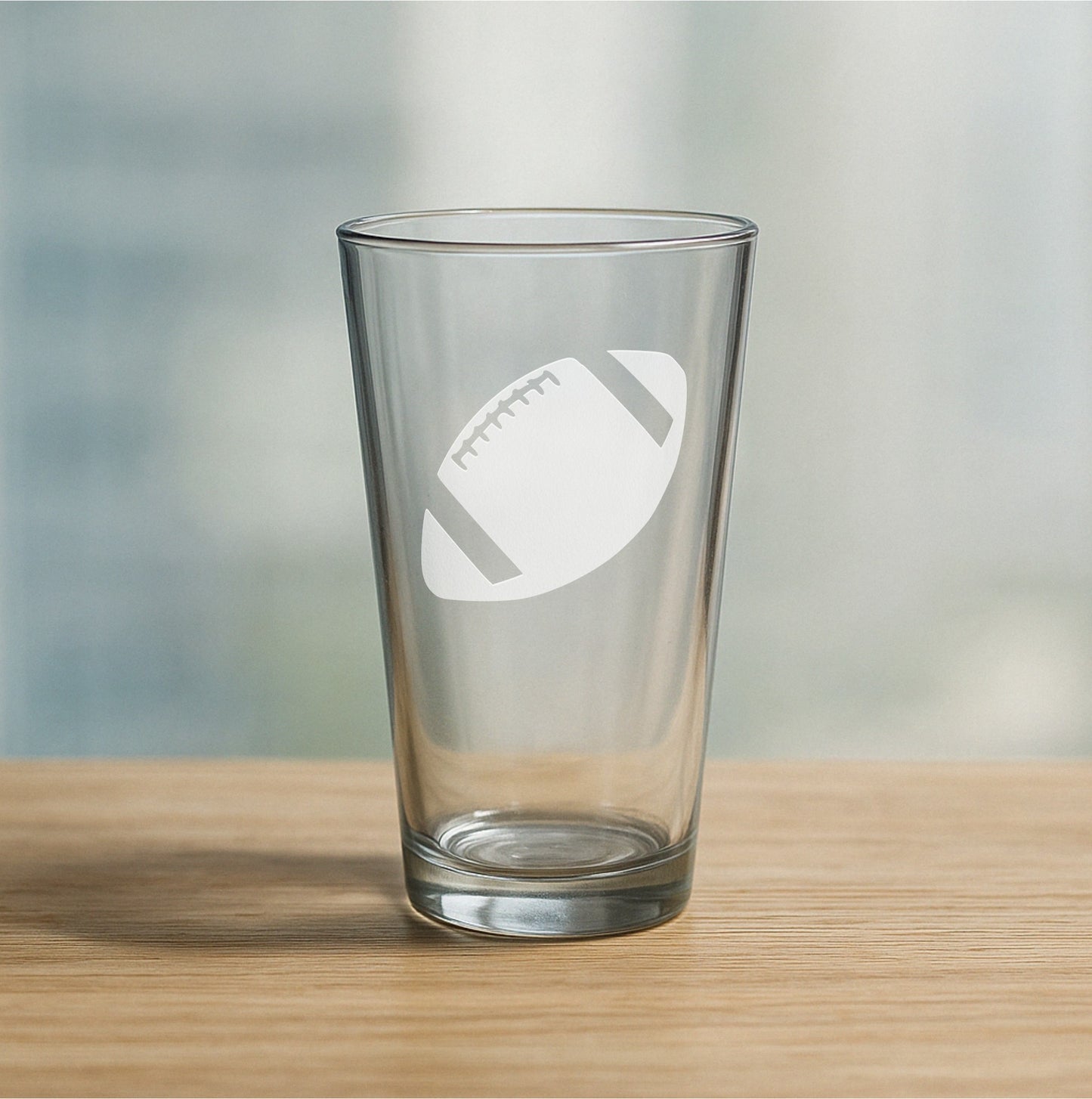 Custom etched pint glass featuring football design – personalized beer glass gift for football players, fans, and tailgate parties