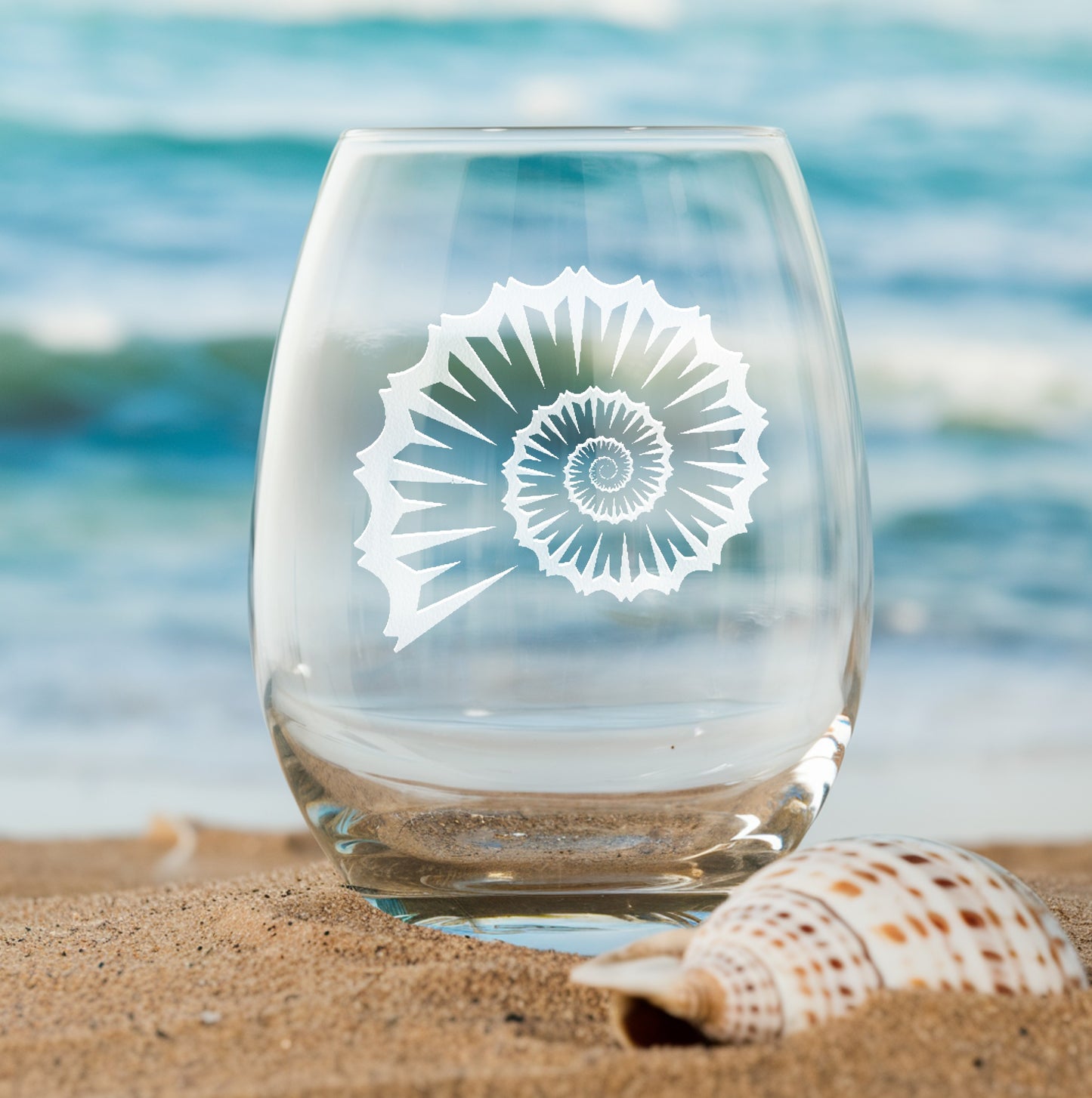 Stemless wine glass with etched swirly sea shell design – perfect gift for beach lovers, ideal for coastal-themed celebrations