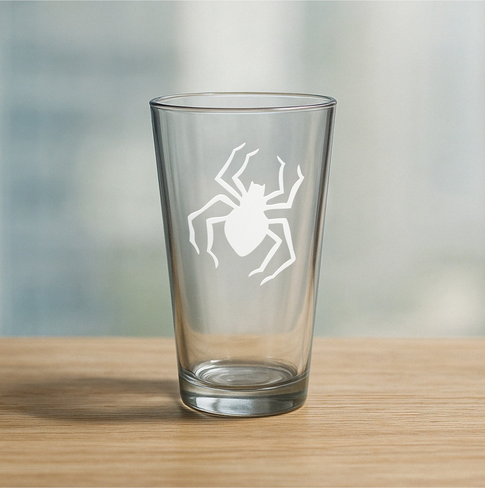 Custom etched pint glass featuring creepy spider design – personalized beer glass gift for Halloween lovers, spider enthusiasts, and spooky season fans